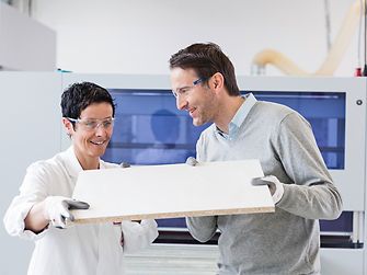Employees with wooden board